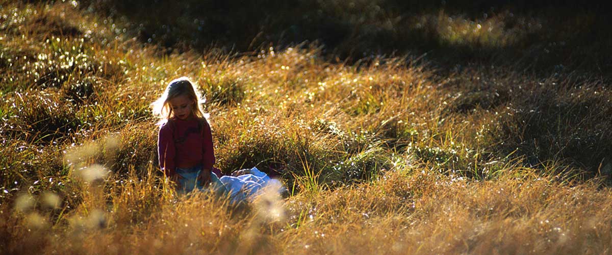 photo of little girl in meadow